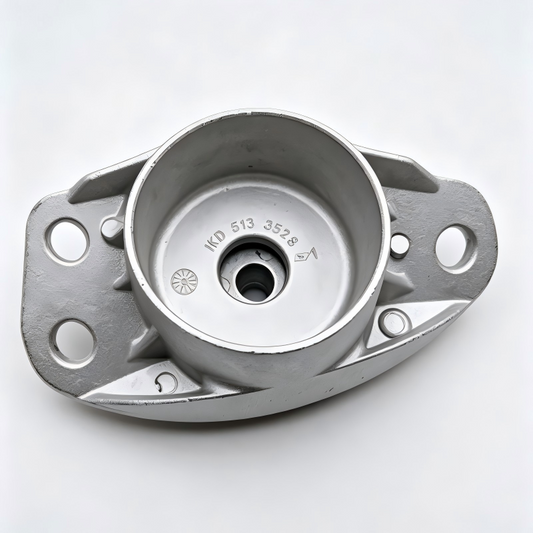Rear shock mount bracket with circular bushing and mounting holes, silver metal