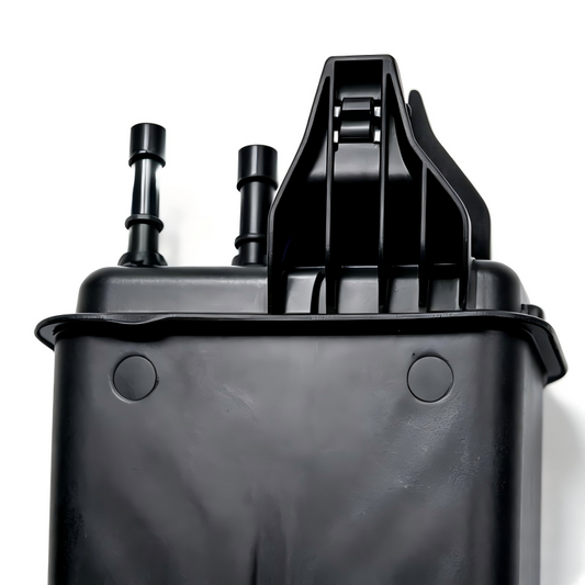 EVAP canister in black plastic, top view with two hose nipples and vent openings