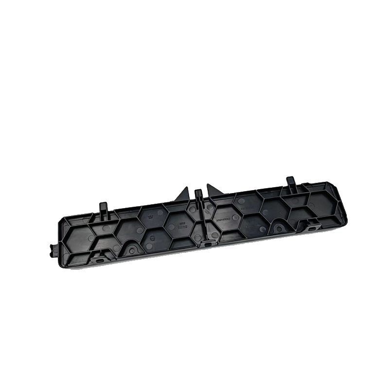 Black plastic cabin air filter cover with hexagonal pattern and mounting tabs