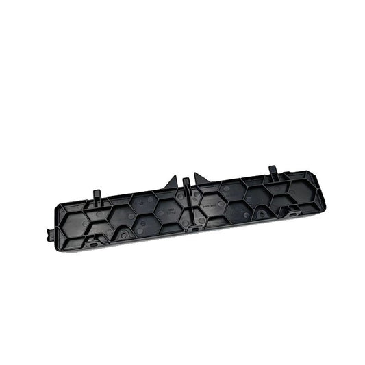 Black plastic cabin air filter cover with hexagonal pattern and mounting tabs
