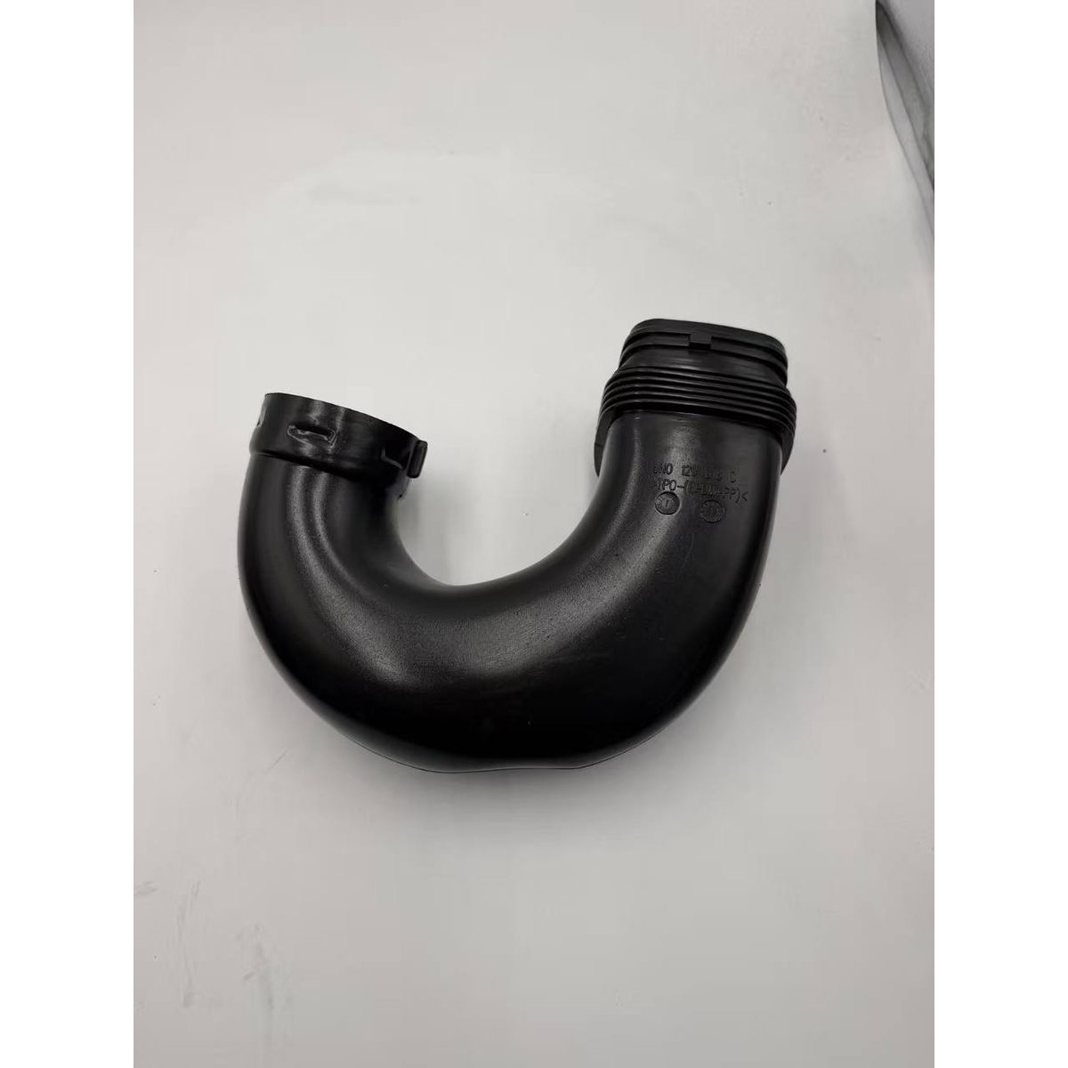 Black plastic air intake duct elbow with two hose ends