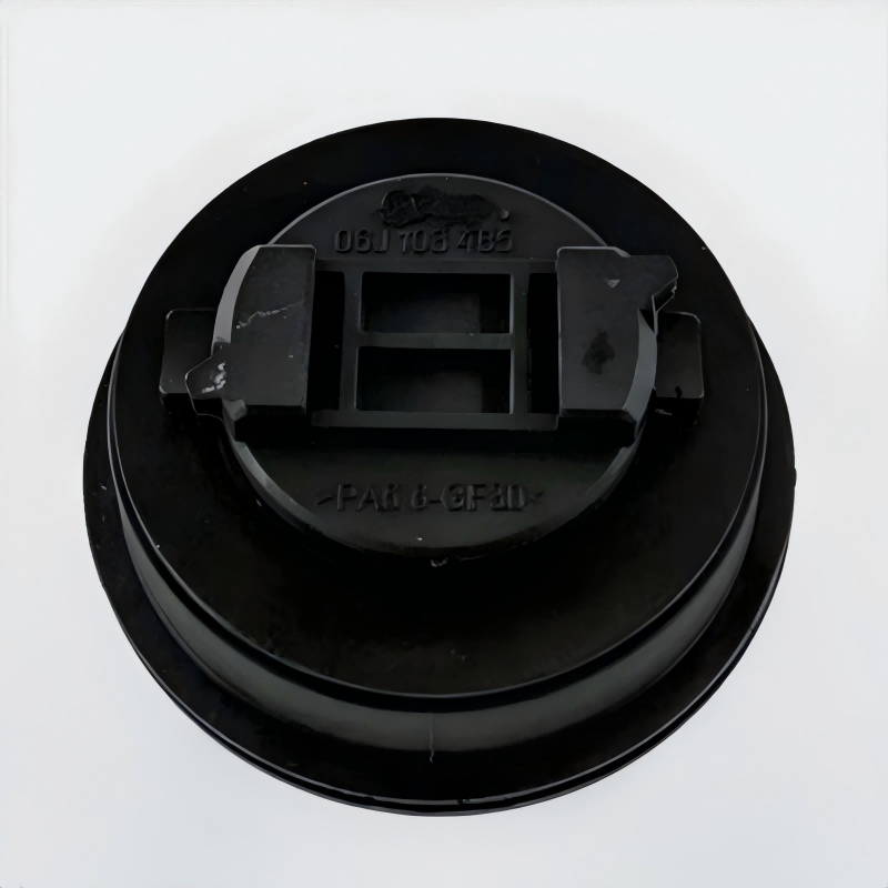 Black engine oil filler cap underside with molded part numbers and clips