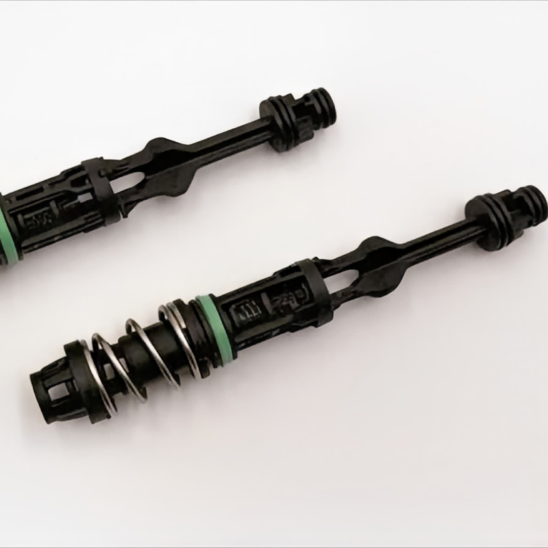 Oil filter housing tube assembly with green ring and coil spring on black stem
