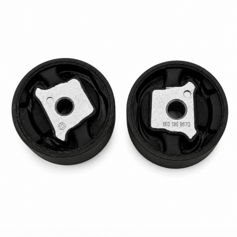 Pair of black subframe bushings with metal mounting plates and central bolt holes