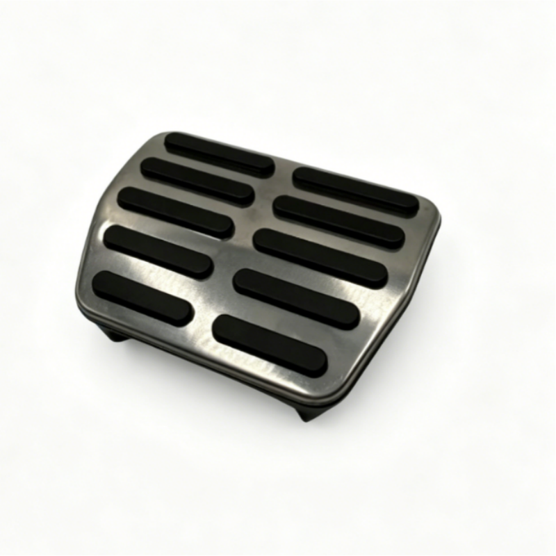 Brake pedal pad with black rubber grip slots, angled view
