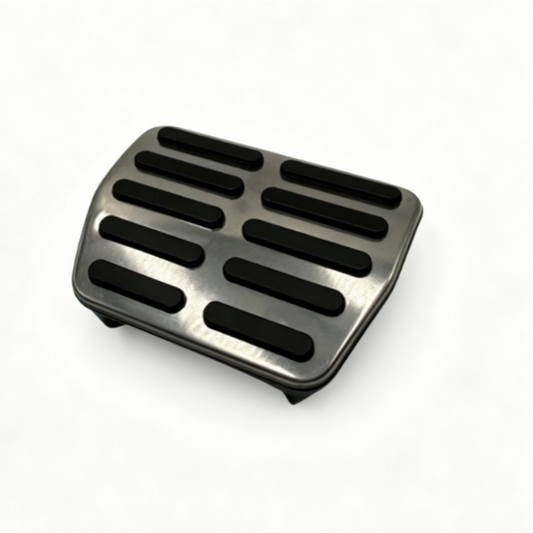 Brake pedal pad with black rubber grip slots, angled view