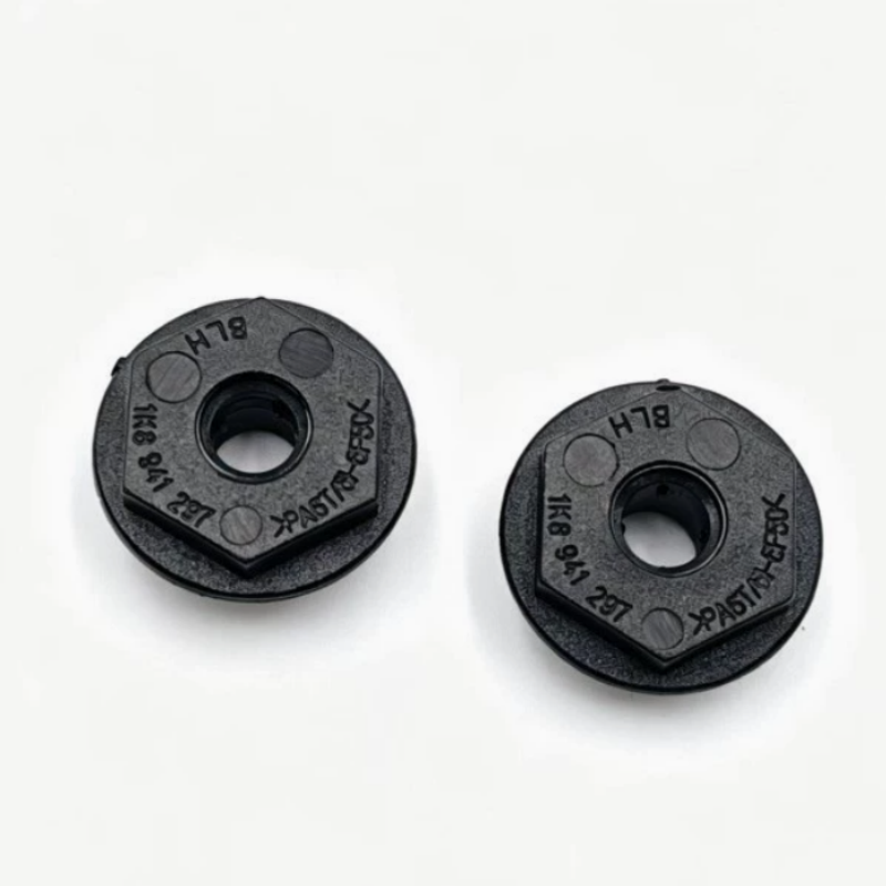Black plastic headlight mounting bracket discs with center hole, stamped details