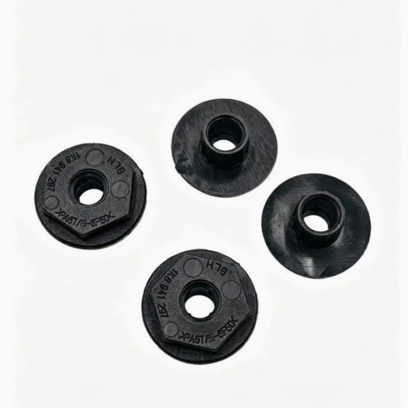 Black headlight mounting bracket pieces with central hole, circular stamped shape