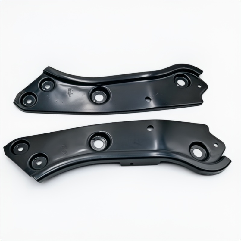 Pair of dark metal headlight mounting brackets with bolt holes and center stud