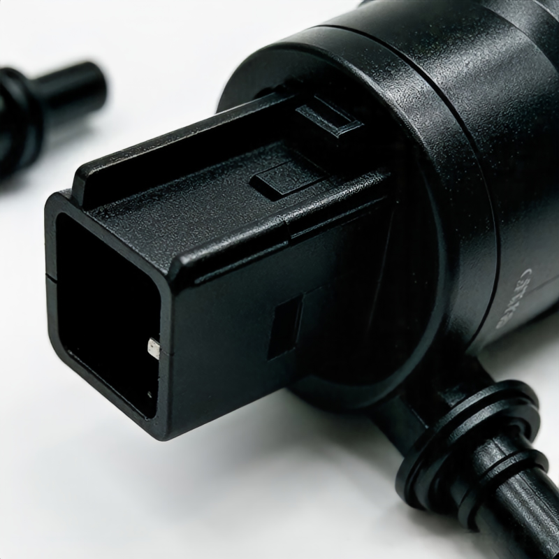 Windshield washer pump with black electrical connector and hose outlet