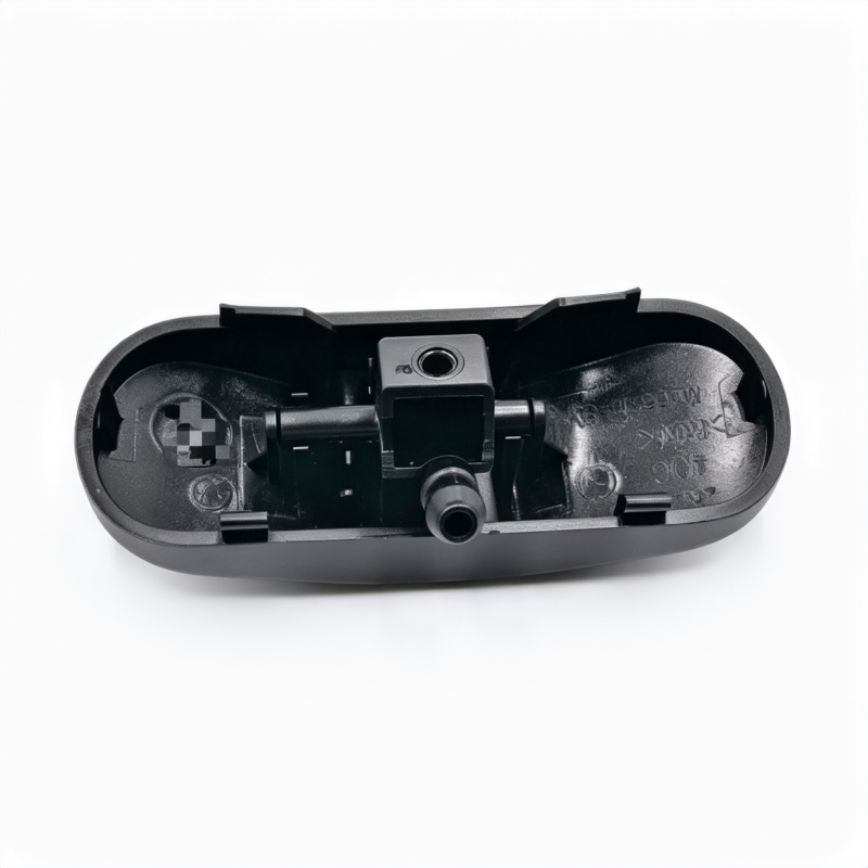 Black windshield washer nozzle assembly with sprayer outlet in open housing