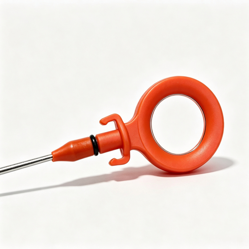 Orange engine oil dipstick with circular handle and metal measurement rod