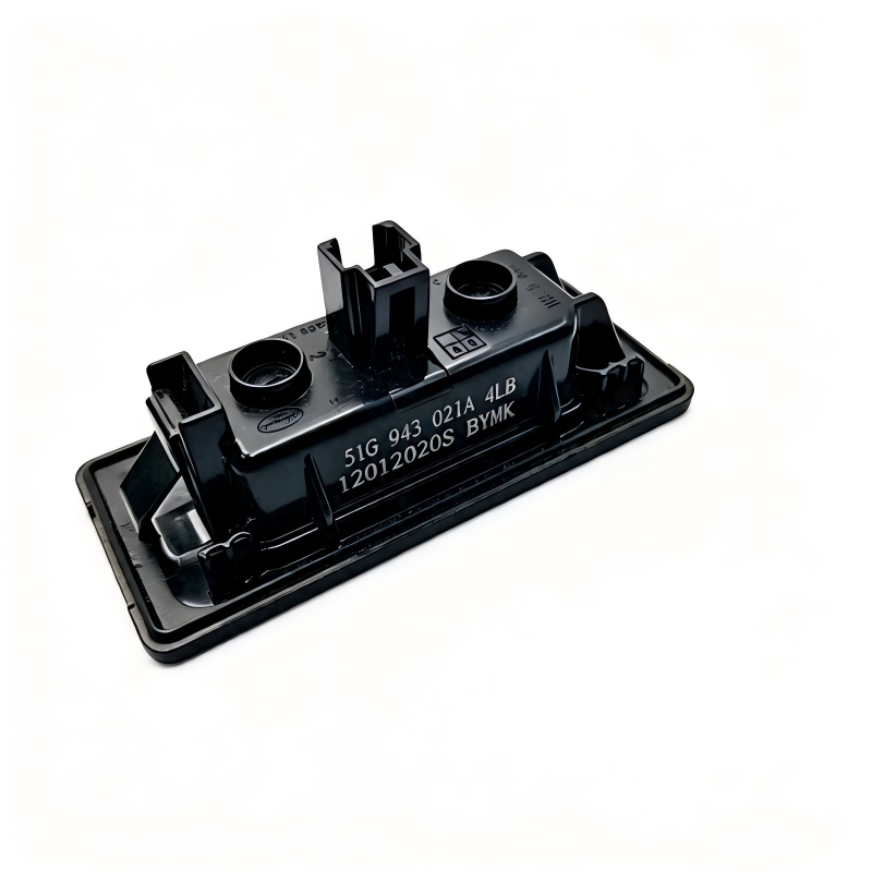 License plate light assembly with black housing and two bulb sockets