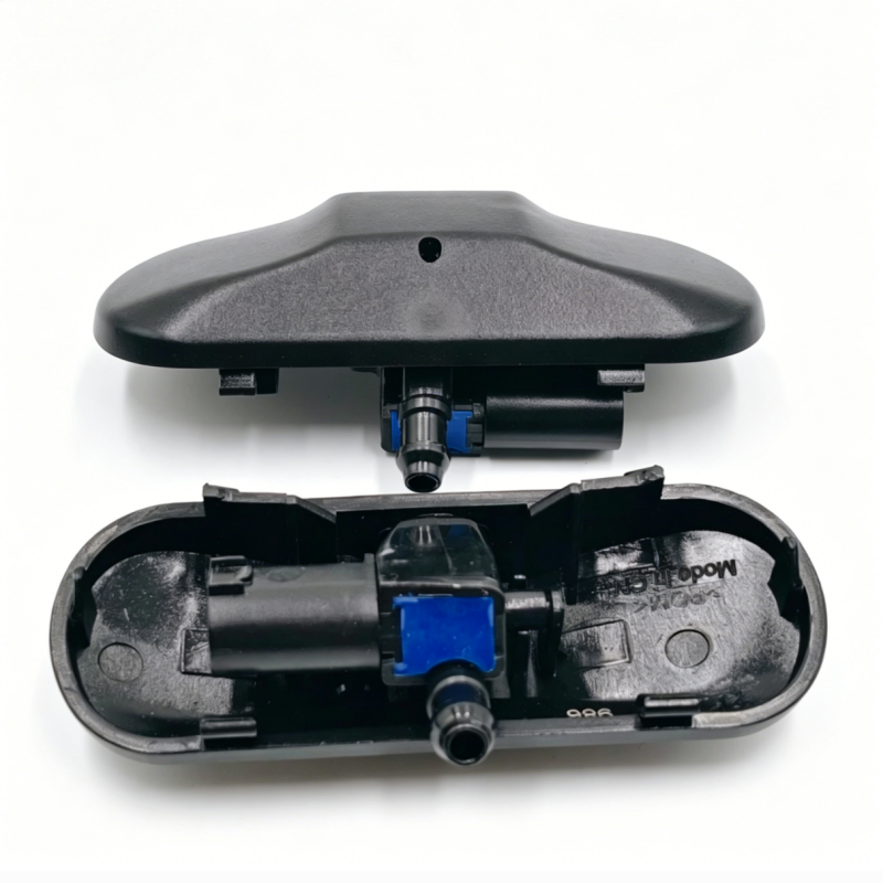 Windshield washer nozzle in black housing with blue center clip and front spray outlet