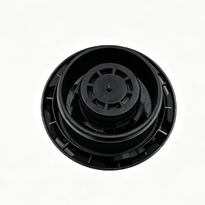 Black coolant reservoir cap underside with central wheel and outer vent channels.