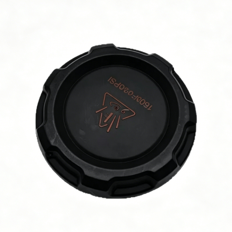 Black coolant reservoir cap with ribbed edge and embossed logo on top.