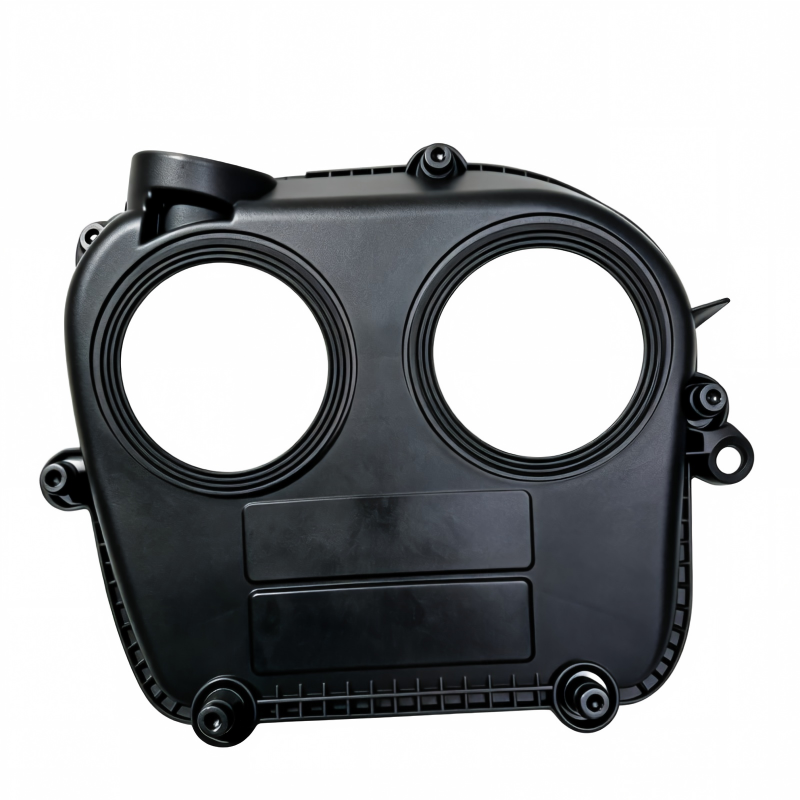 Black timing belt cover housing with two round openings and side hose outlet