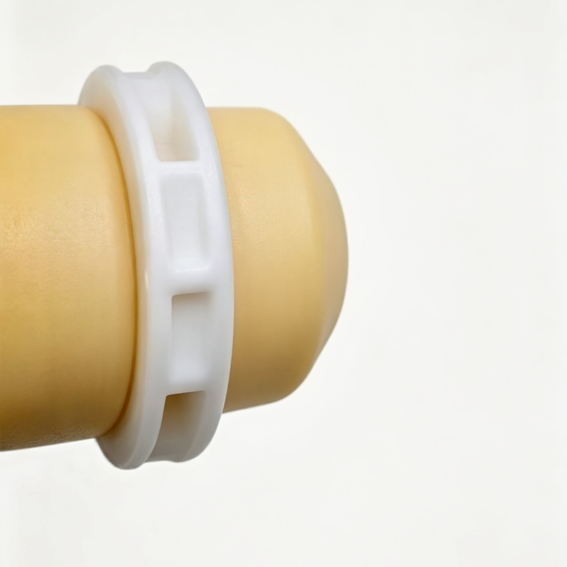 Beige shock bump stop with white plastic mounting ring detail