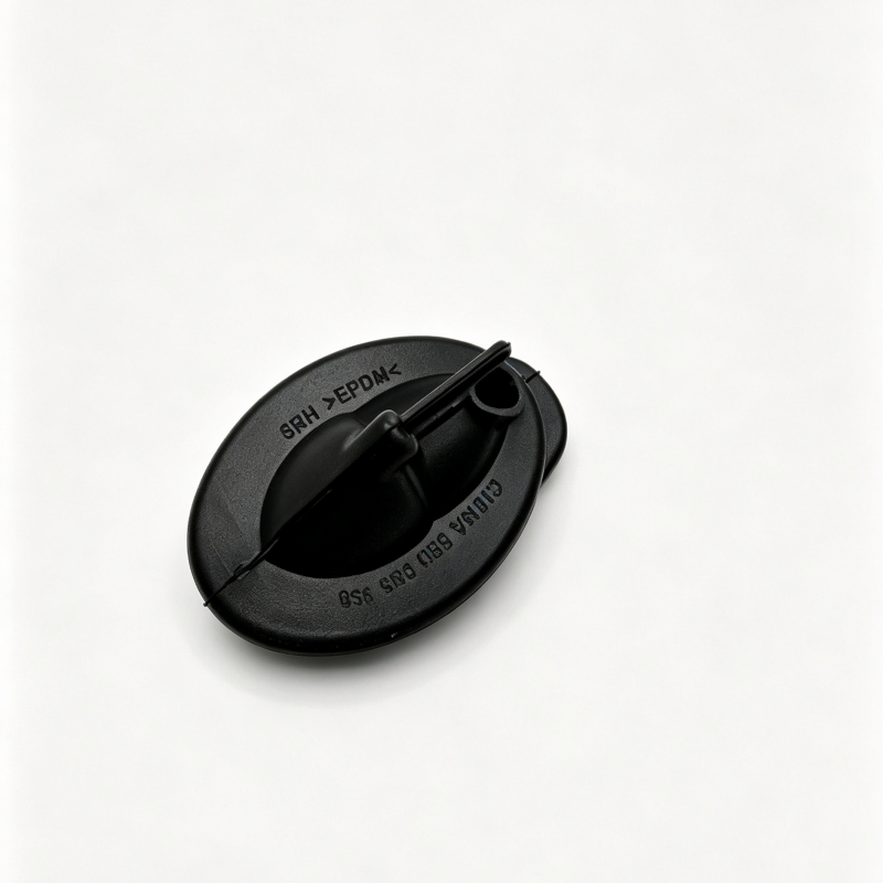 Black windshield washer hose grommet, top view with molded ridges and outlet