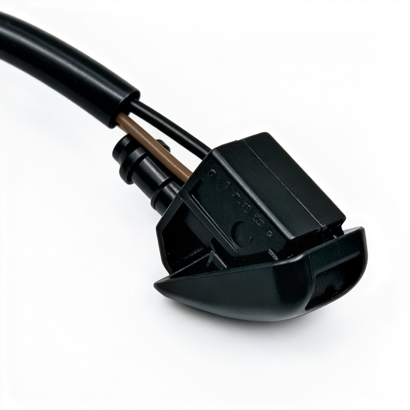 Windshield washer nozzle housing with two black connectors and brown inner tube