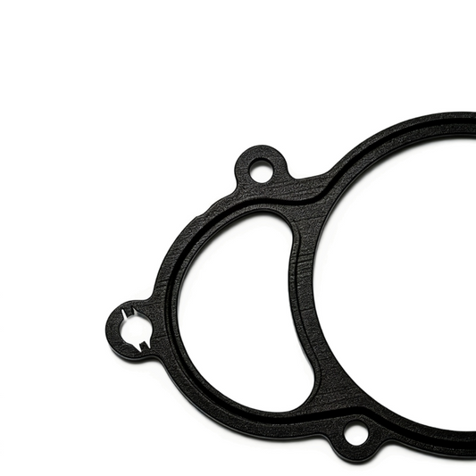 Black exhaust gasket showing circular seal opening and oval spacer cutout