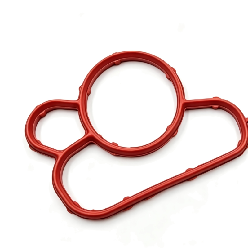 Oil filter housing gasket set with three red gaskets and circular cutouts