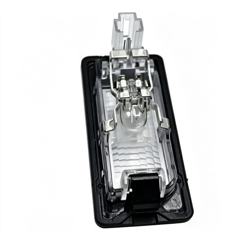 License plate light housing with inner bracket and wiring connector, underside view