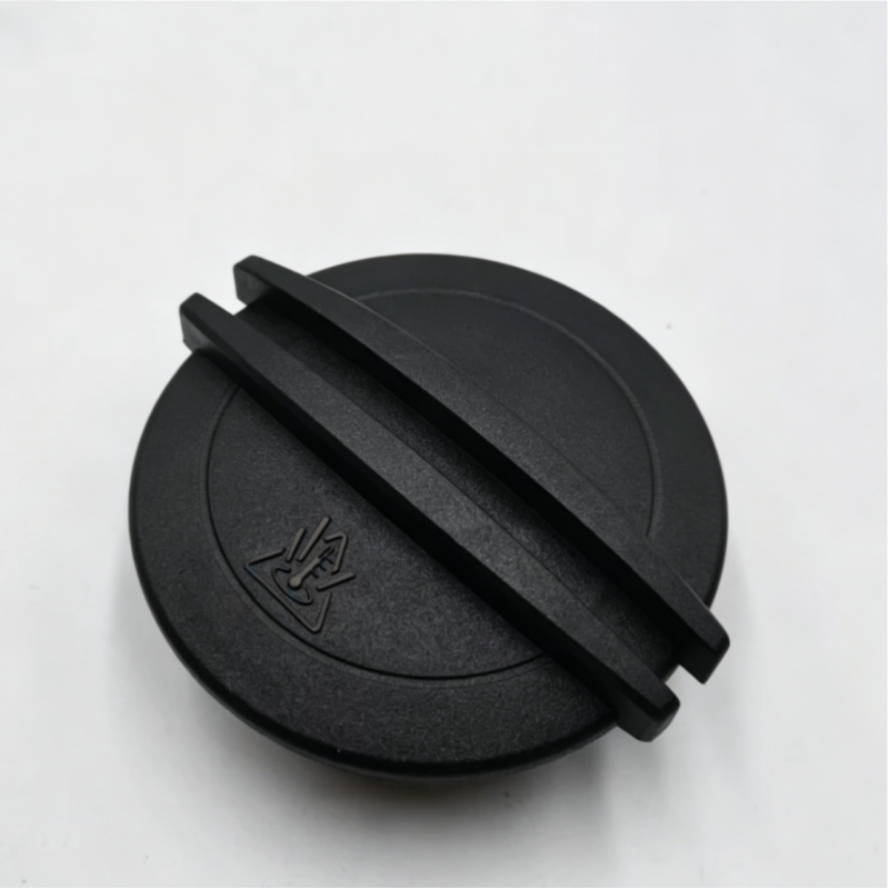 Coolant reservoir cap, black plastic with two parallel ridges and embossed markings