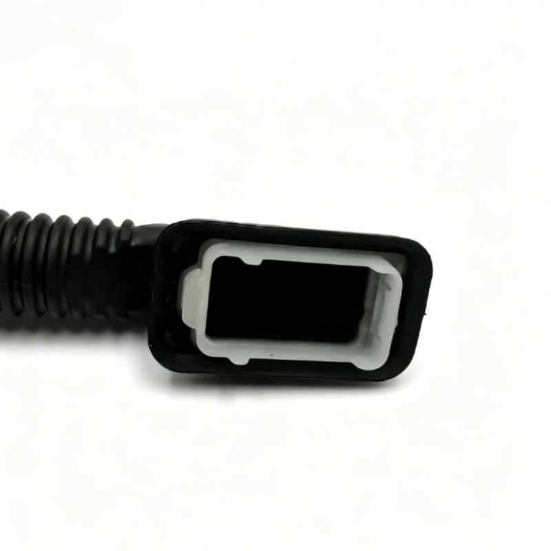 Black corrugated wiring sleeve with rectangular connector housing, close-up