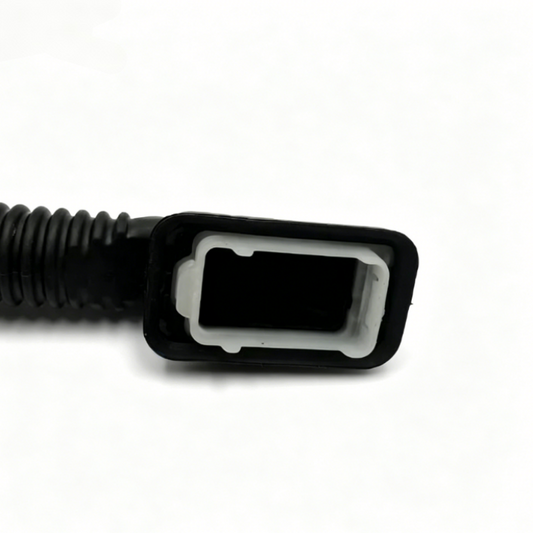 Black corrugated wiring sleeve with rectangular connector housing, close-up