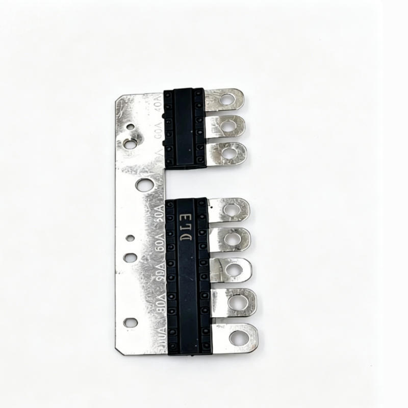 Multi fuse strip plate with black fuse blocks and five metal terminal prongs.