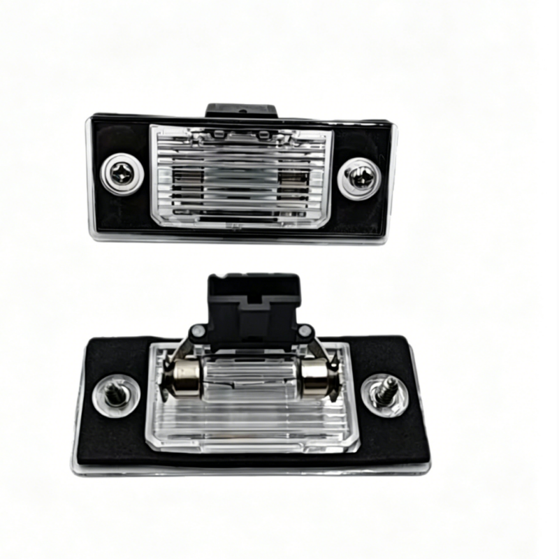 License plate light assembly showing clear lens, chrome reflector, and black housing