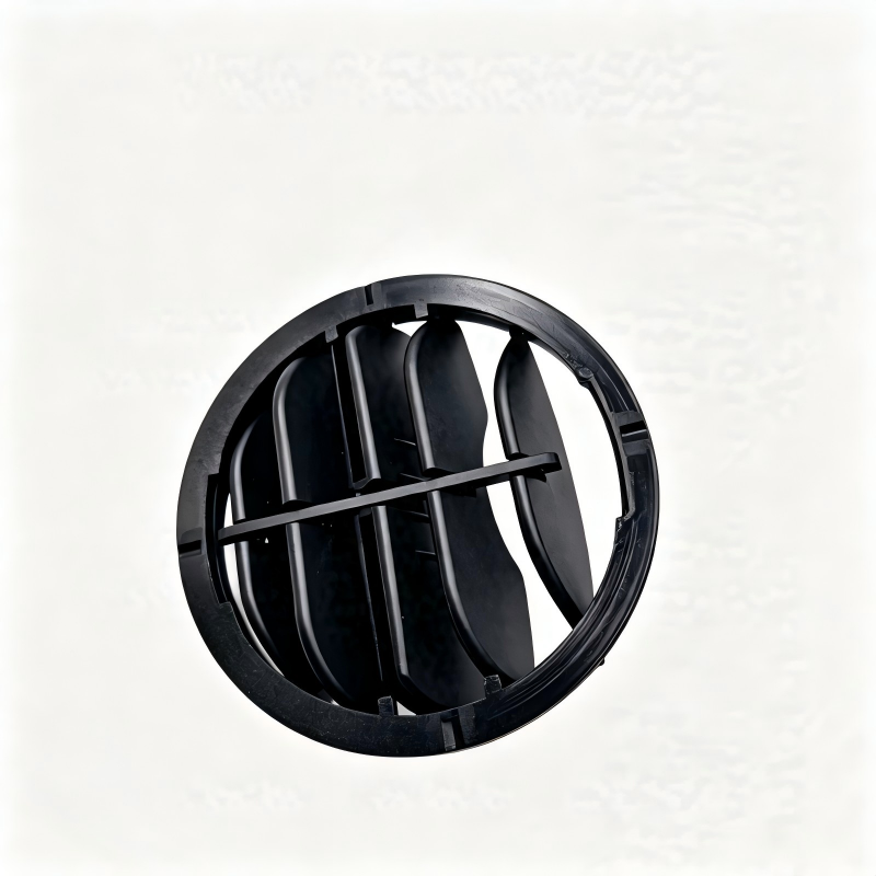 Black circular air vent grille insert with curved slats and mounting tabs
