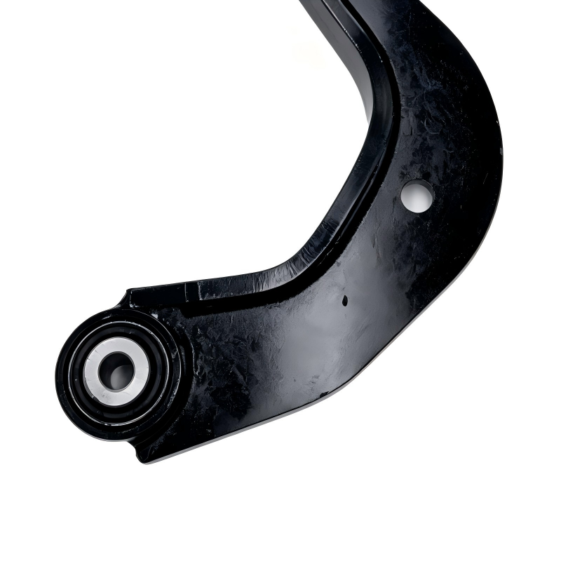 Control arm bracket end bushing on curved black steel arm with mounting hole.