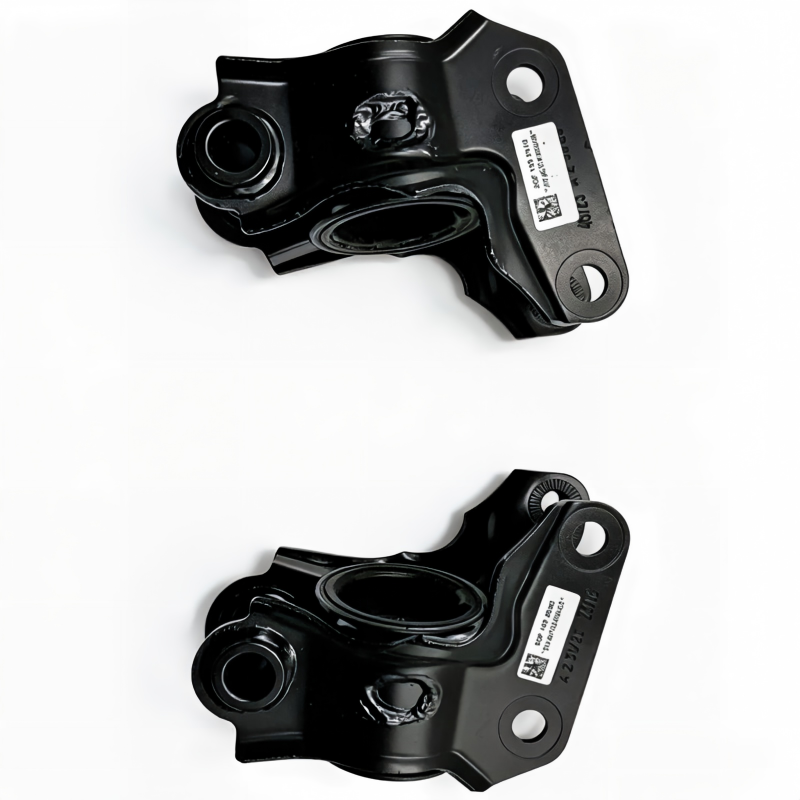 Pair of black control arm brackets with bushing openings and mounting bolt holes