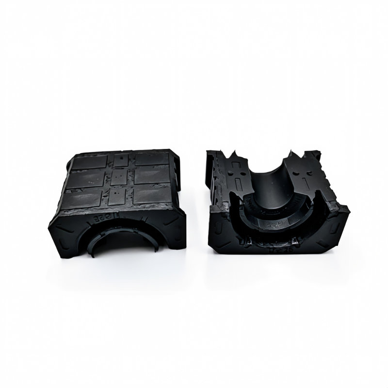 Stabilizer bar bushing, black rubber housing shown front and side