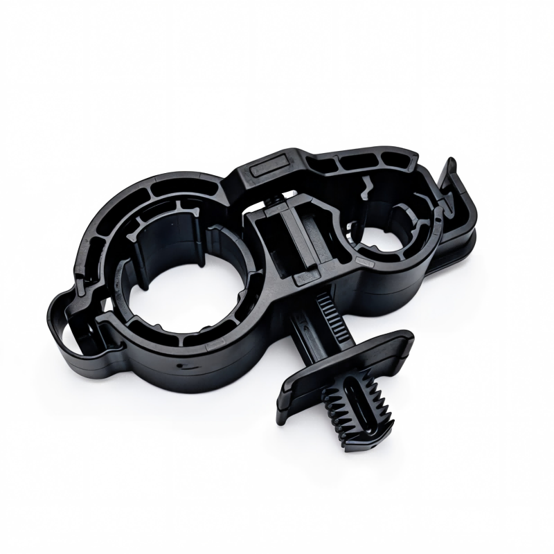 Black A/C pipe bracket base with two circular openings and side spring clip