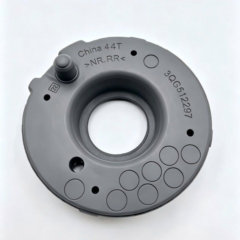 Automotive coil spring pad, gray circular insulator with central hole and mounting holes