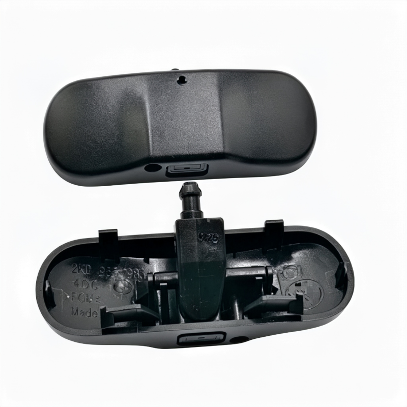 Black windshield washer nozzle assembly with open cover and side vent ports