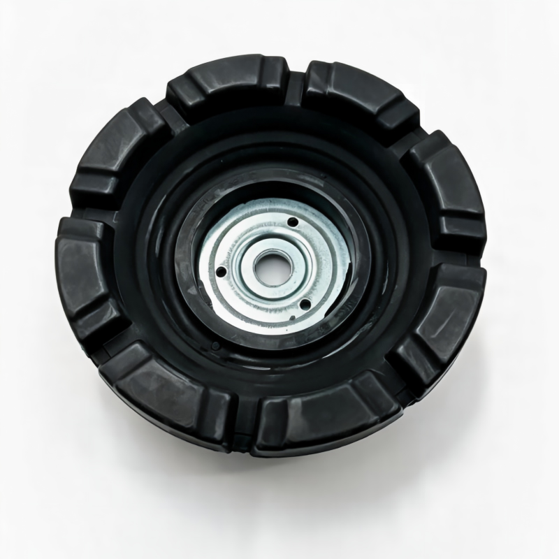 Front strut mount bushing assembly, top view of black rubber housing with steel insert